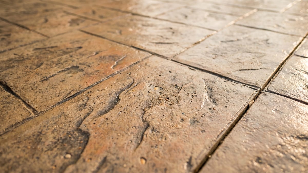 Detail of a stamped and colored concrete patio finish in warm earth tones